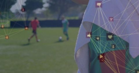 Soccer Player Resting on Field with Digital Icon Overlay