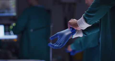 Surgeons Gloving Up for Surgery in Operating Room