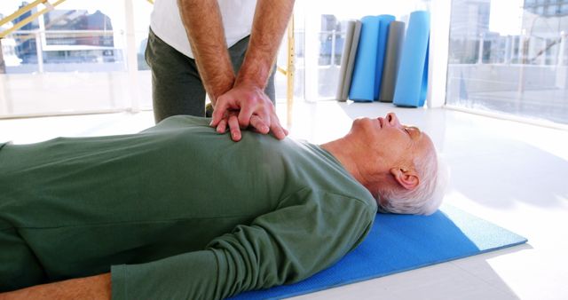 Older Man Receiving CPR on Yoga Mat in Bright Room - Download Free Stock Images Pikwizard.com