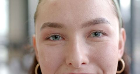 Close-Up of Woman with Blue Eyes and Hoop Earrings
