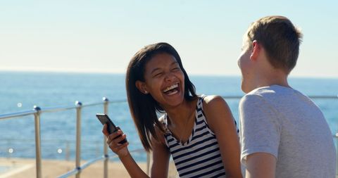 Diverse Friends Laughing Together by Sunny Seaside