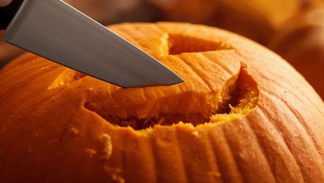 Close-Up Carving Smiling Pumpkin for Halloween Festivities