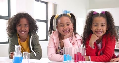 Smiling children engaging in fun science laboratory experiment