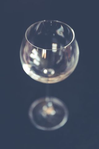 Elegant Empty Crystal Wine Glass Against Dark Background