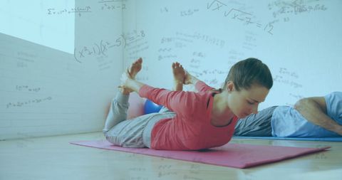 Couple Exercising at Home with Mathematical Overlays Concept