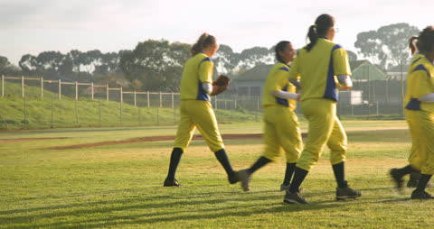 Female Team Running and Training on Baseball Field