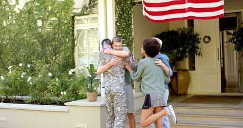 Joyful Reunion of Soldier with Friends at Home - Download Free Stock Images Pikwizard.com
