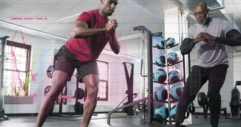 Trainer guiding athlete performing lateral lunge with medicine ball rack in modern gym