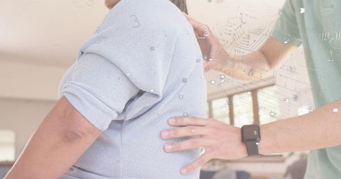 Caregiver guiding senior woman supporting mobility and comfort home care assistance