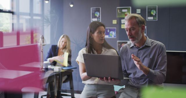 Business Professionals Discussing Work on Laptop in Modern Office - Download Free Stock Images Pikwizard.com