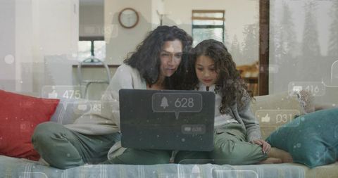 Mother and daughter sharing laptop on couch with floating social media notifications