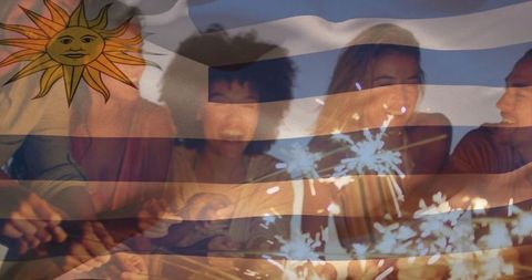 Joyful Celebration with Friends and Sparklers Under Uruguay Flag
