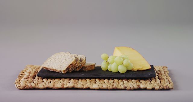Elegant Cheese and Grapes Snack with Bread on Woven Placemat - Download Free Stock Images Pikwizard.com