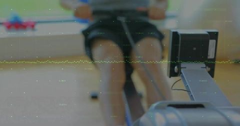 Determined athlete rowing indoor for fitness goals