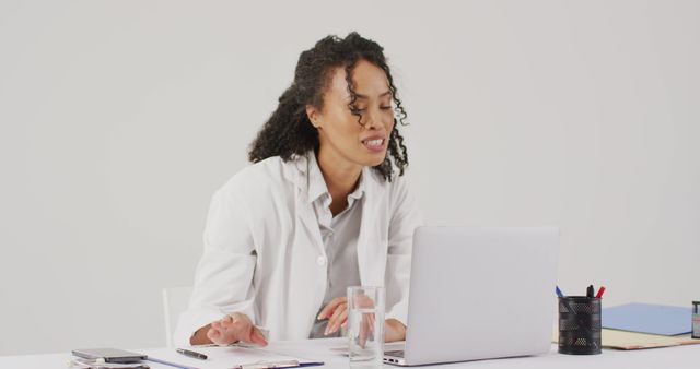 Confident Female Doctor Using Laptop at Desk in Office - Download Free Stock Images Pikwizard.com