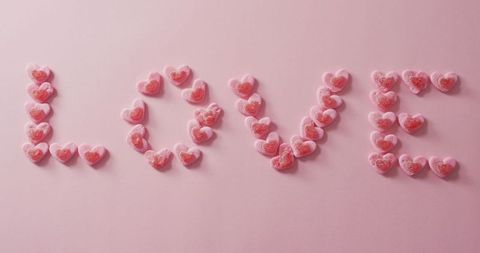 Heart-Shaped Candy Spelling Love on Pink Background - Download Free Stock Images Pikwizard.com