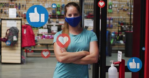 Masked woman in sports store with social media icons