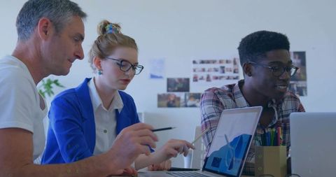 Diverse Team Collaborating at Workplace on Computer Project