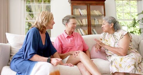 Joyful Senior Women Enjoying Friendly Conversation Indoors