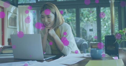 Asian Woman Having Video Call on Laptop at Home with Overlay Effects