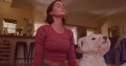 Relaxed Woman Meditating at Home with Adorable Dog Companion