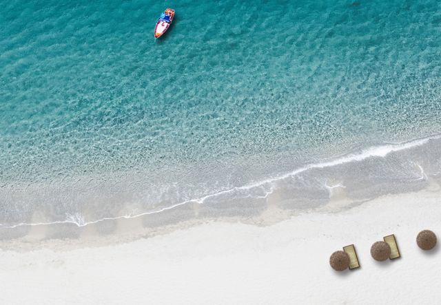 Top view of serene tropical beach with kayak and umbrellas - Download Free Stock Photos Pikwizard.com