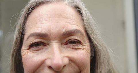 Close-up of Smiling Senior Woman Outdoors Embracing Natural Beauty