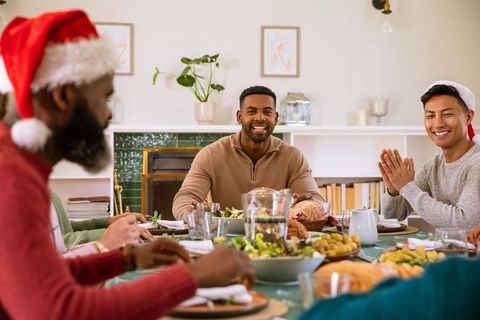 Diverse Friends Celebrating Christmas Dinner with Joyful Atmosphere