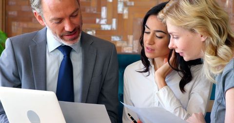 Diverse Business Team Collaborating on Project Analysis