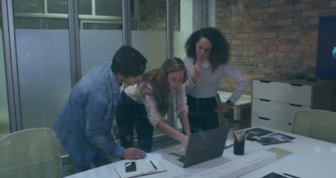 Diverse Team Collaborating on Office Project with Data Graphics