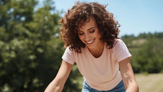 Smiling woman enjoying nature in sunlit meadow