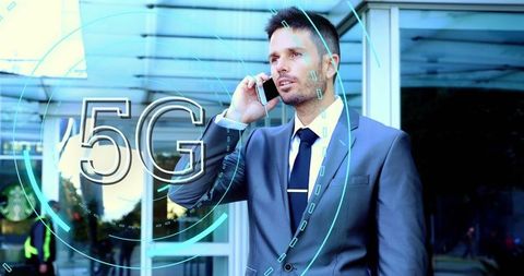 Businessman engaging in 5g mobile communication outside office