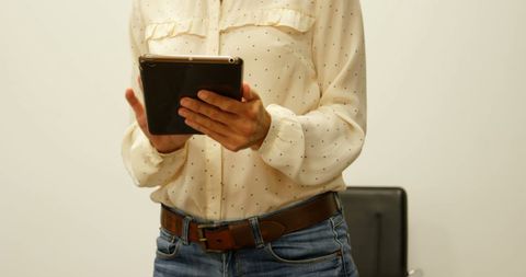 Businesswoman Using Tablet in Office for Remote Work