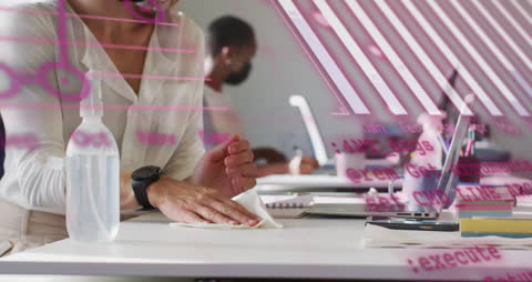 Woman Disinfecting Desk in Office with Digital Data Overlay