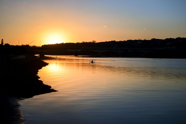 Serene Sunrise Over River with Kayaker in Calm Waters - Download Free Stock Photos Pikwizard.com