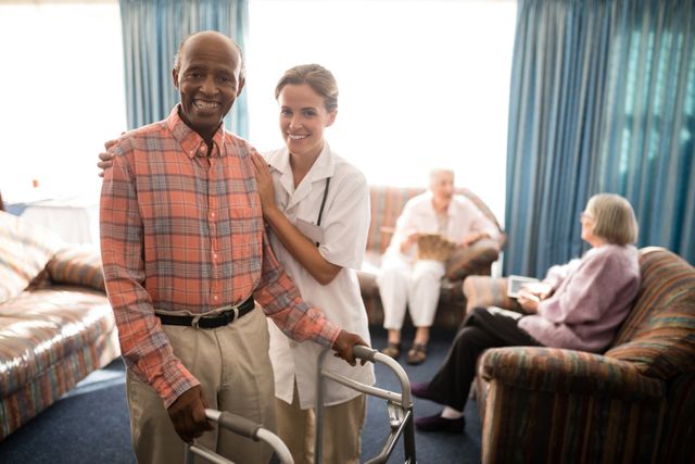 Smiling female doctor stands beside an elderly man using a walker in a retirement home. The background shows other seniors engaging in activities, creating a warm and supportive environment. This image is ideal for use in healthcare, senior living, and caregiving promotional materials, illustrating compassionate care and support for the elderly.