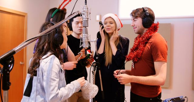 Friends Singing Christmas Carols in Recording Studio Wearing Festive Attire - Download Free Stock Images Pikwizard.com