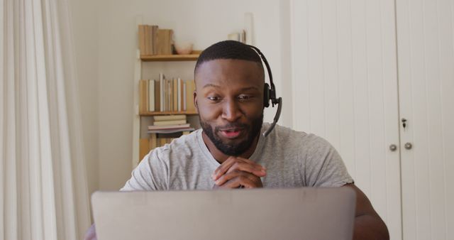 Confident African American man having video call with headset - Download Free Stock Images Pikwizard.com