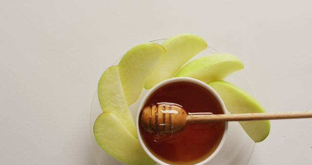 Image of honey in jar and apple slices lying on white surface. food, cooking, baking, taste and flavour concept.