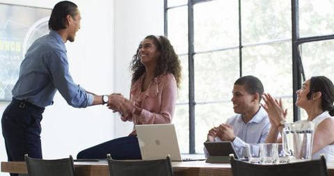 Diverse Business Team Celebrating Success in Office Setting