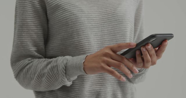 Person Using Smartphone in Casual Grey Sweater - Download Free Stock Images Pikwizard.com