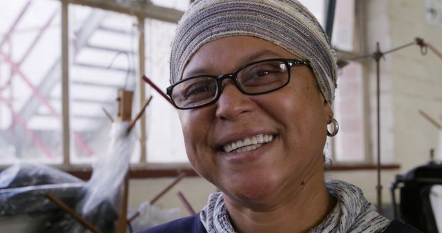 Smiling Woman in Headscarf Near Industrial Machines and Pipes - Download Free Stock Images Pikwizard.com