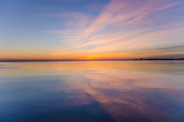 Serene Sunset Over Calm Sea with Reflection - Download Free Stock Photos Pikwizard.com