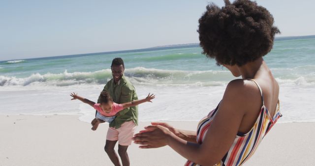 Family Enjoying Fun Playtime at Beach with Ocean Waves - Download Free Stock Images Pikwizard.com