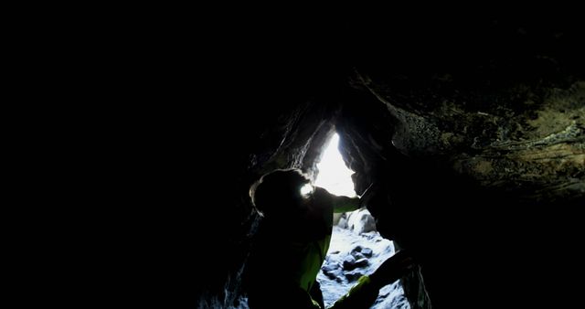 Person Exploring Dark Cave with Headlamp Adventure Background - Download Free Stock Images Pikwizard.com