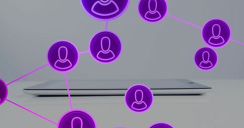 Closed slim laptop showing neon avatar network connecting remote teams and devices