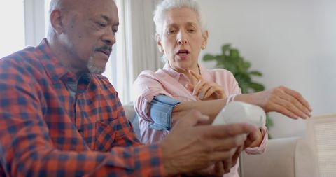 Senior Couple Checking Blood Pressure at Home