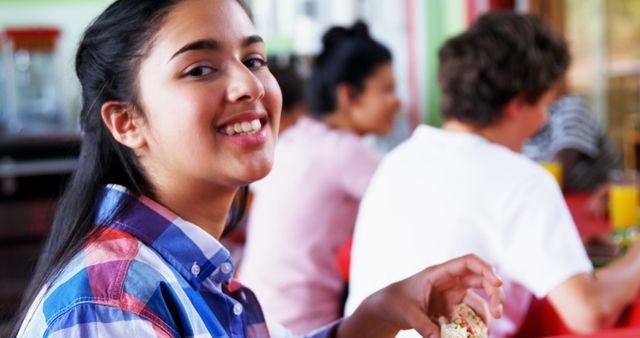 Smiling Asian Girl Enjoying Meal at Vibrant Restaurant - Download Free Stock Images Pikwizard.com