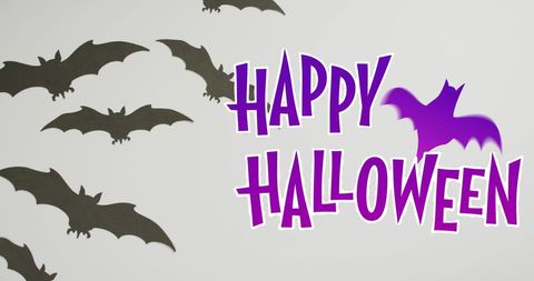 Happy Halloween Text with Black Bats and Purple Bat Silhouette