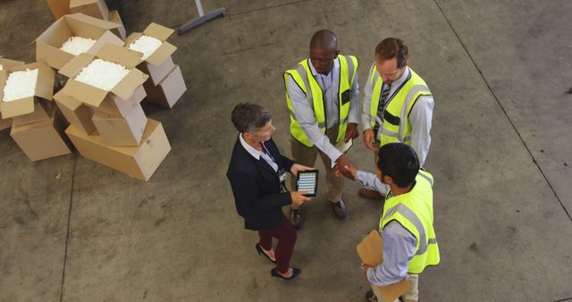 Warehouse workers discussing logistics with manager - Download Free Stock Images Pikwizard.com